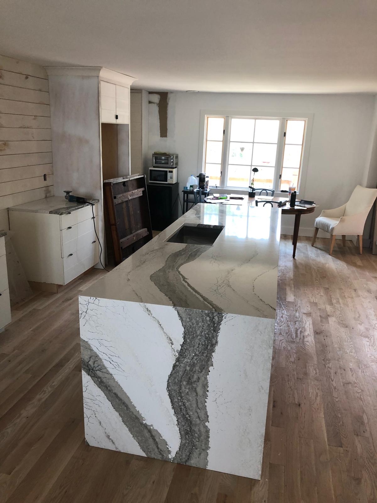 A kitchen with a large island in the middle of the room.