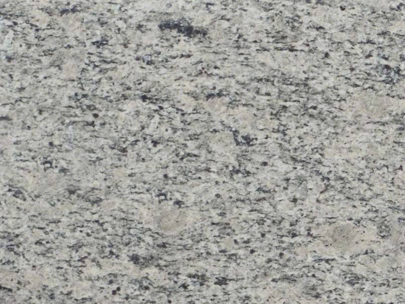 A close up of a white granite counter top.