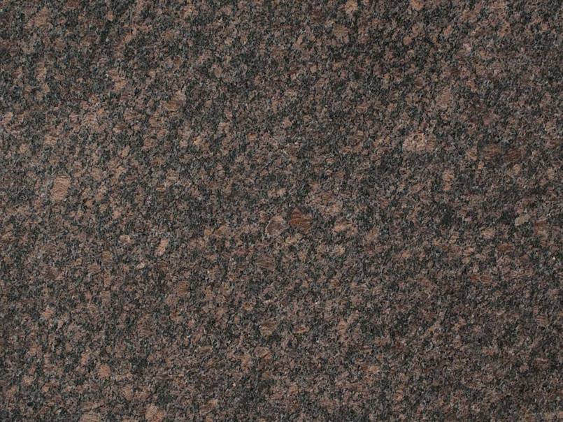 A close up of a brown granite counter top.
