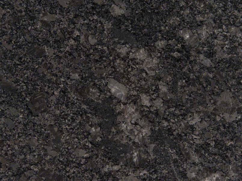 A close up of a black granite counter top.