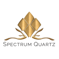 A logo for spectrum quartz with a gold diamond in the middle.