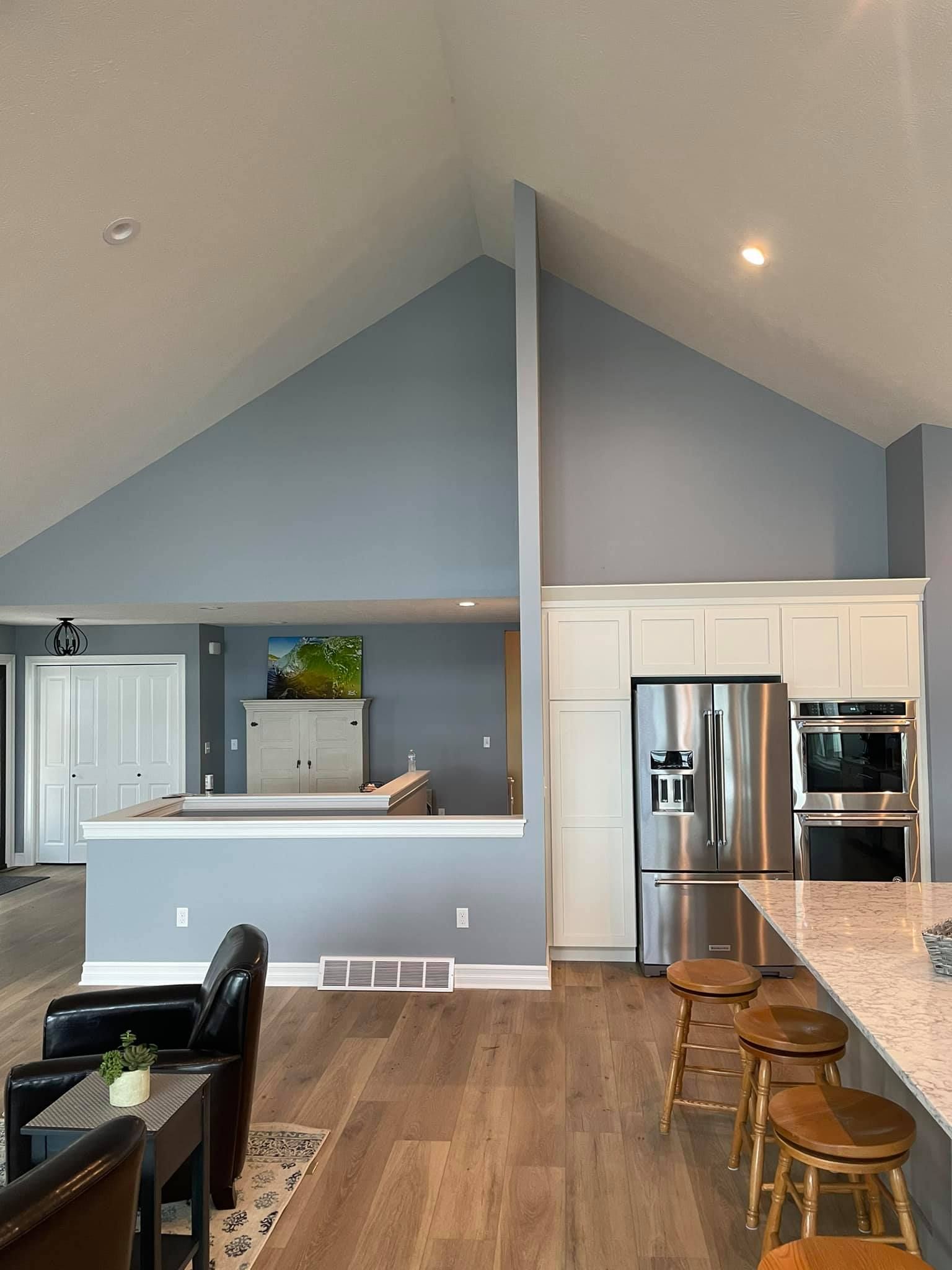 A kitchen with stainless steel appliances and a vaulted ceiling