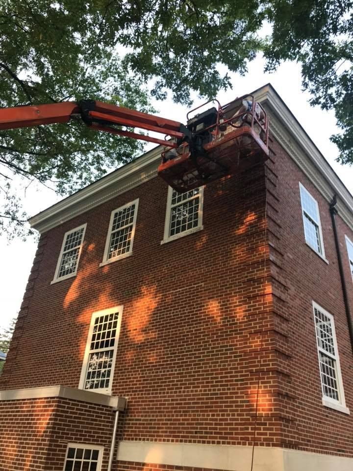 A brick building with a crane on top of it