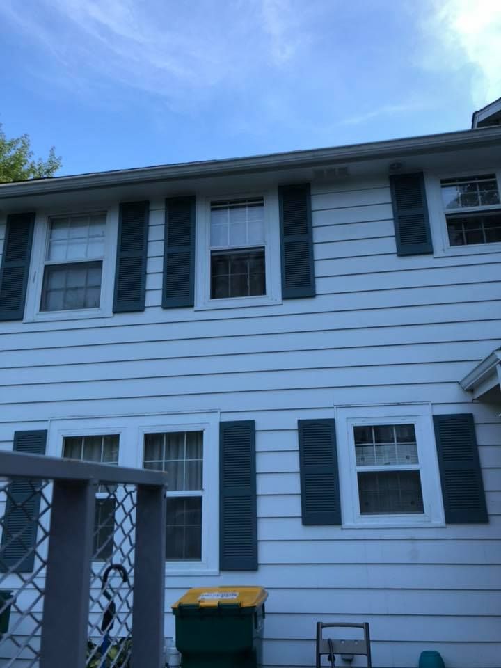 A white house with black shutters on the windows
