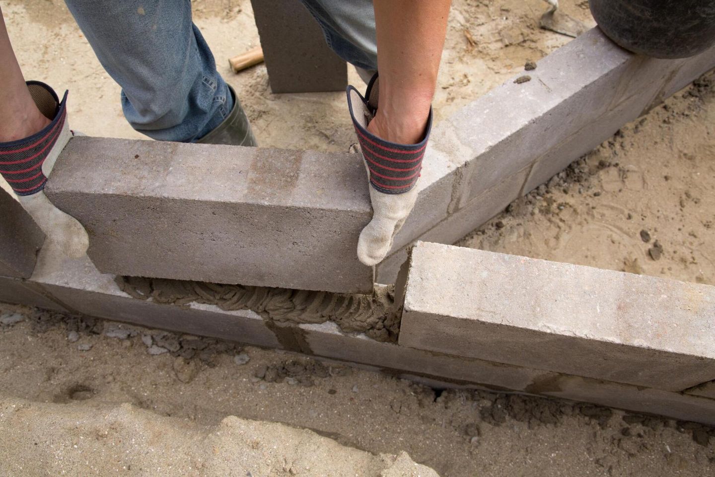 worker carrying the concrete block