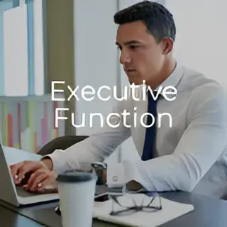 A man is sitting at a table using a laptop computer