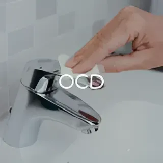 A person is cleaning a bathroom sink faucet with a cloth