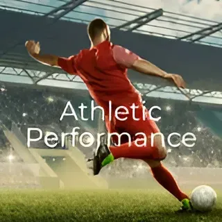 A soccer player is kicking a soccer ball in a stadium