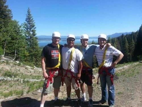 Four men posing for a picture with one wearing a shirt that says norway