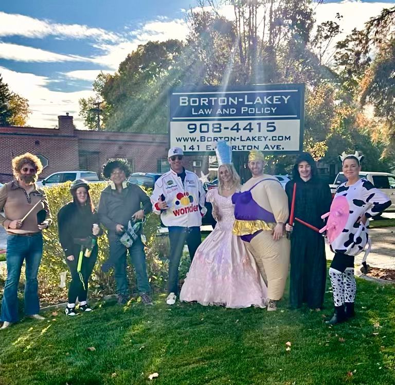 A group of people standing in front of a sign for borton-lakey law and policy