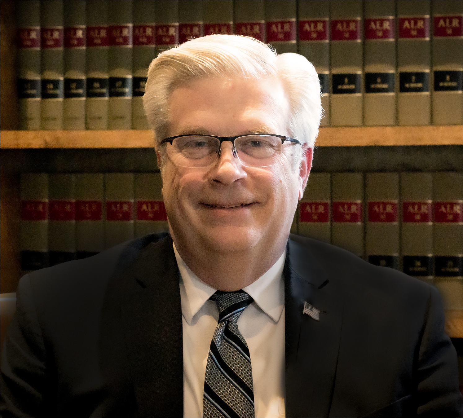 Todd Lakey in a suit and tie is smiling for the camera.