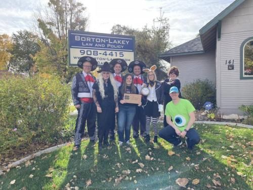 A group of people posing in front of a sign that says borton lakey law and police