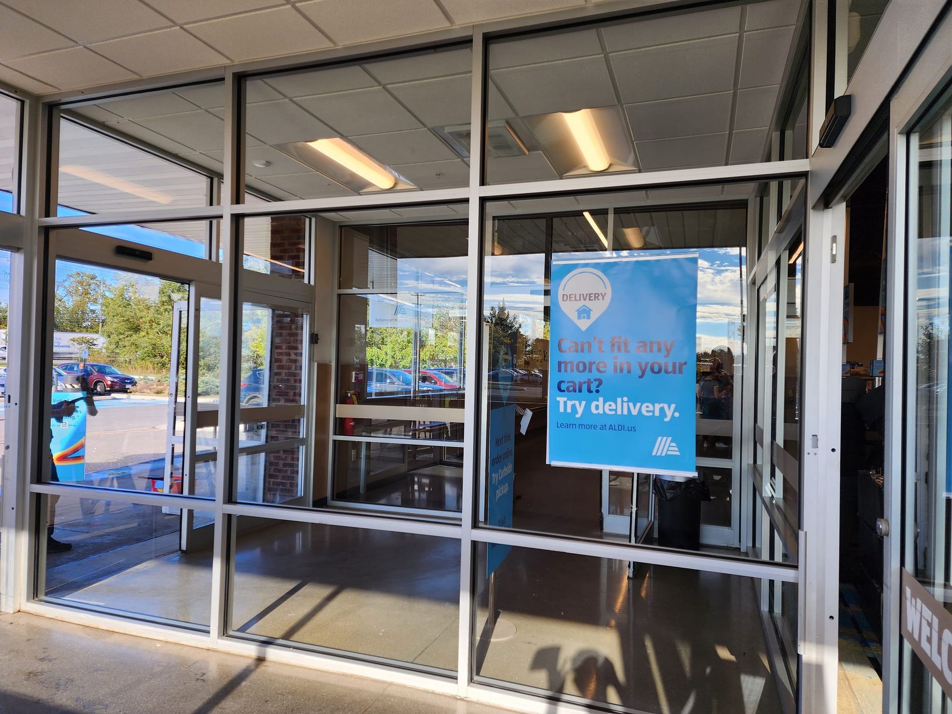 Glass storefront entrance with sign: 