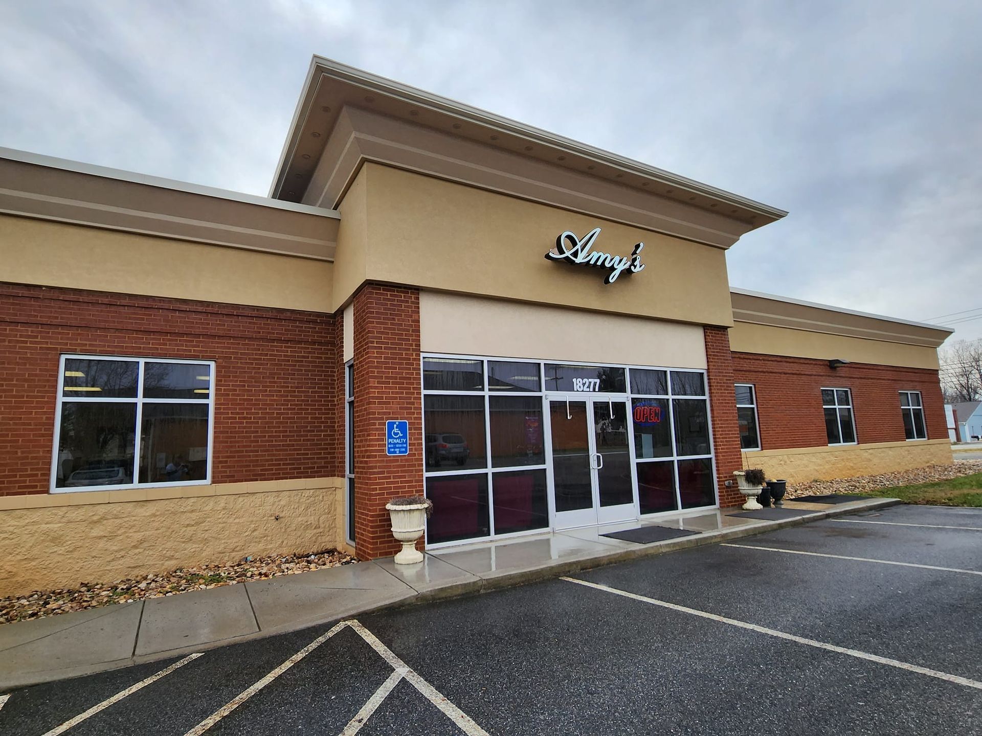 A brick and tan-colored building with a sign that reads 