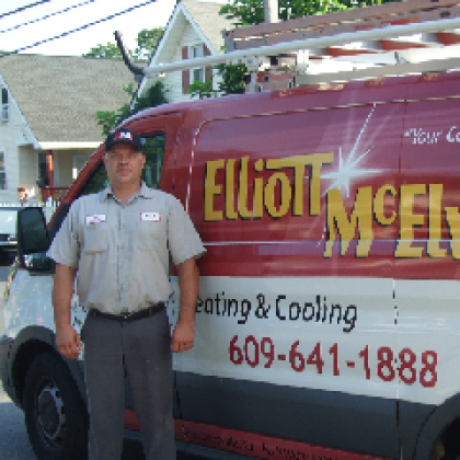 A man standing in front of an Elliott-Mcelwee van