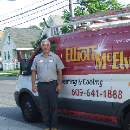 A man stands in front of an Elliott-Mcelwee y van