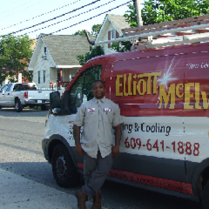 A man stands in front of a Elliott-Mcelwee van