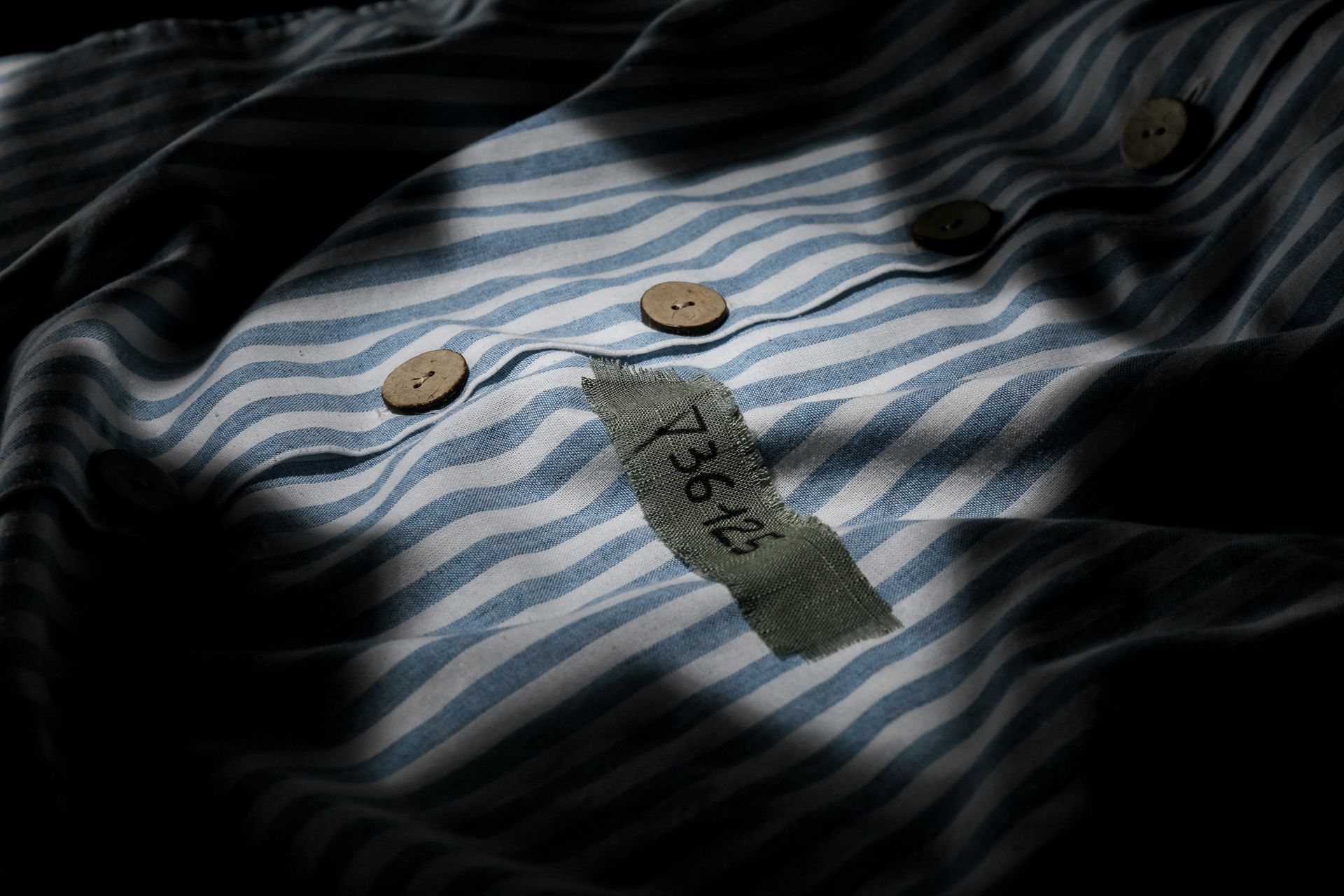 a striped shirt with a tag that says 73612 on it