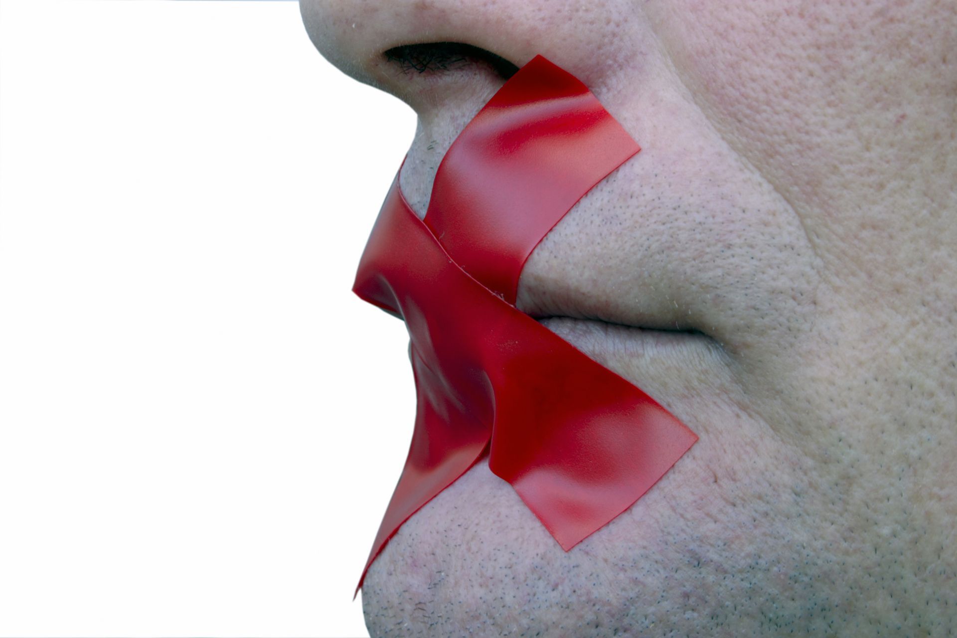 a close up of a person's mouth with red tape on it