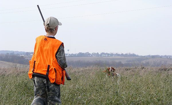Young Boy Holding A Gun Looking At The Dog — Tacoma, WA — Pheasants Forever