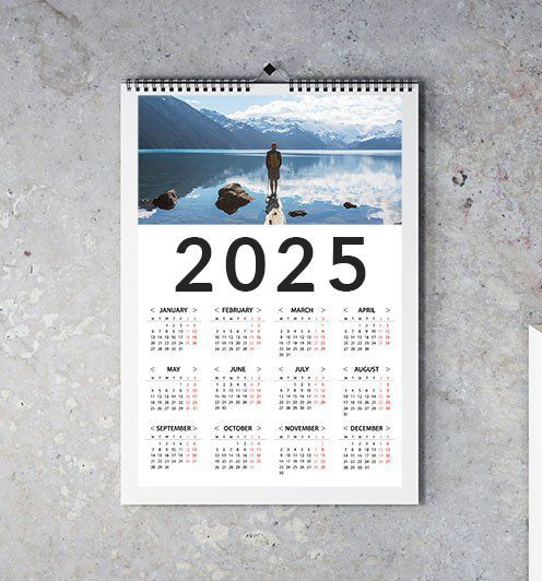 2025 Calendar hanging on grey wall.