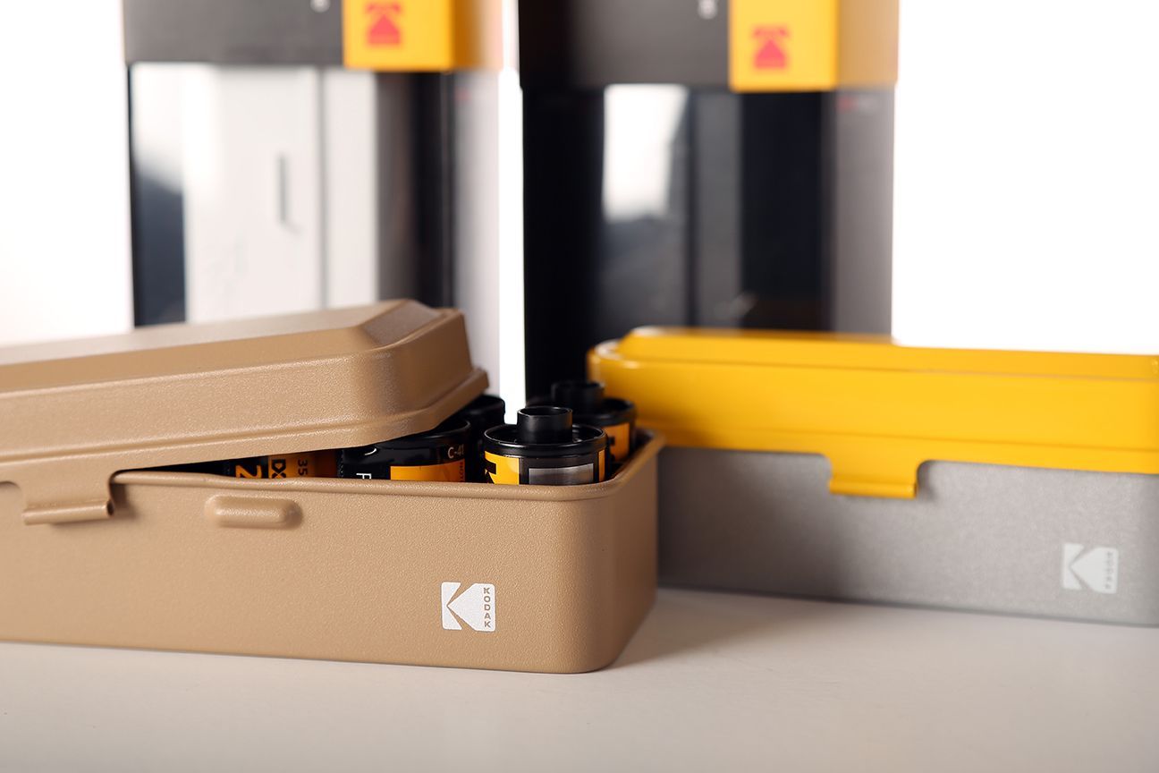 Tan and silver/yellow Kodak film case.