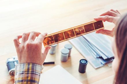 Woman holding a strip of 35mm negatives