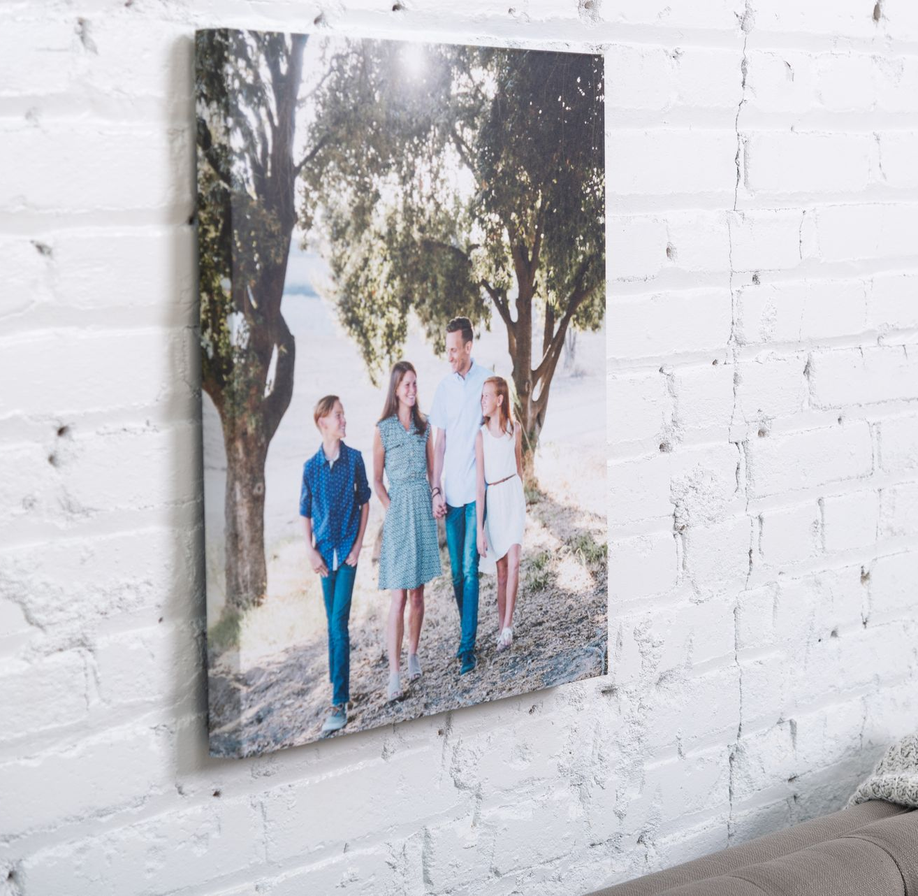 Large canvas of London hanging on wall behind grey couch.