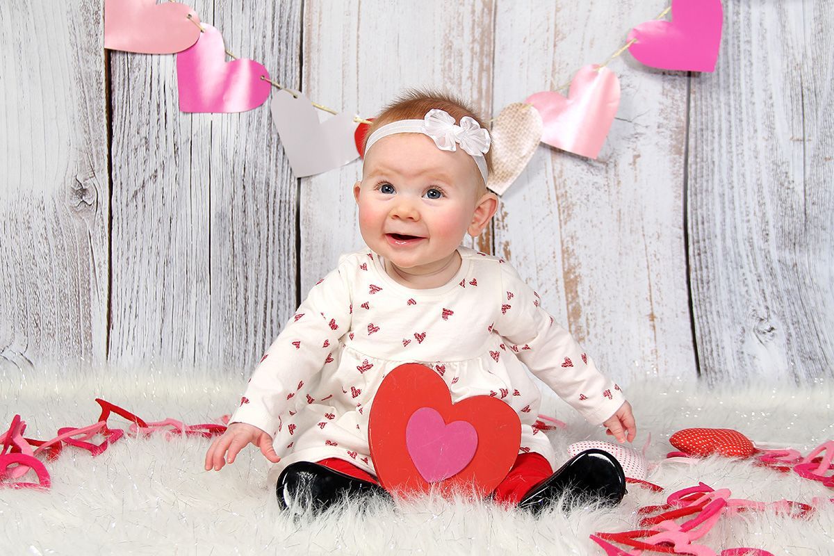 Child surrounded by Valentine's Day decoration