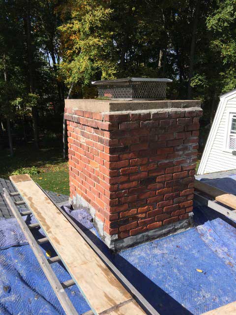Chimney with Ladder and Plywood – West Springfield, MA – Rolandini Brothers Masonry