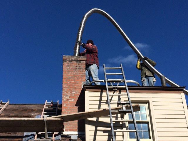 Installing the Steel Liner in Chimney – West Springfield, MA – Rolandini Brothers Masonry