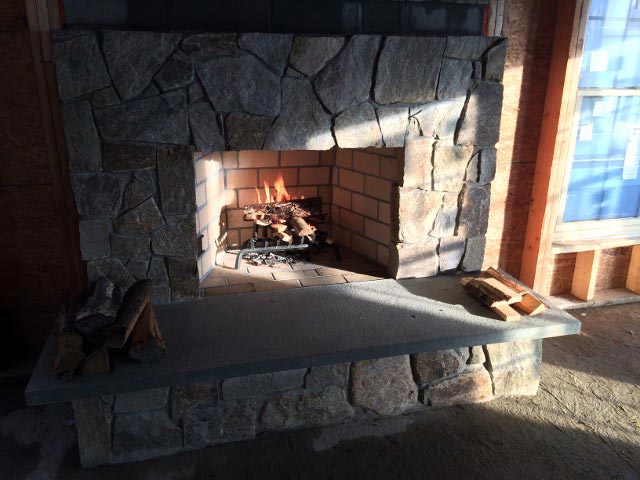 Stone Fireplace with Fire – West Springfield, MA – Rolandini Brothers Masonry