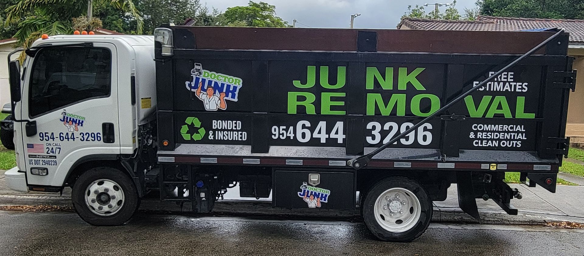 White and black junk removal truck with
