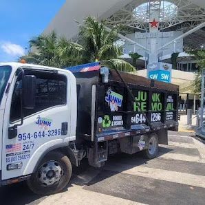 Junk removal truck parked in front of a building with a Heineken sign.