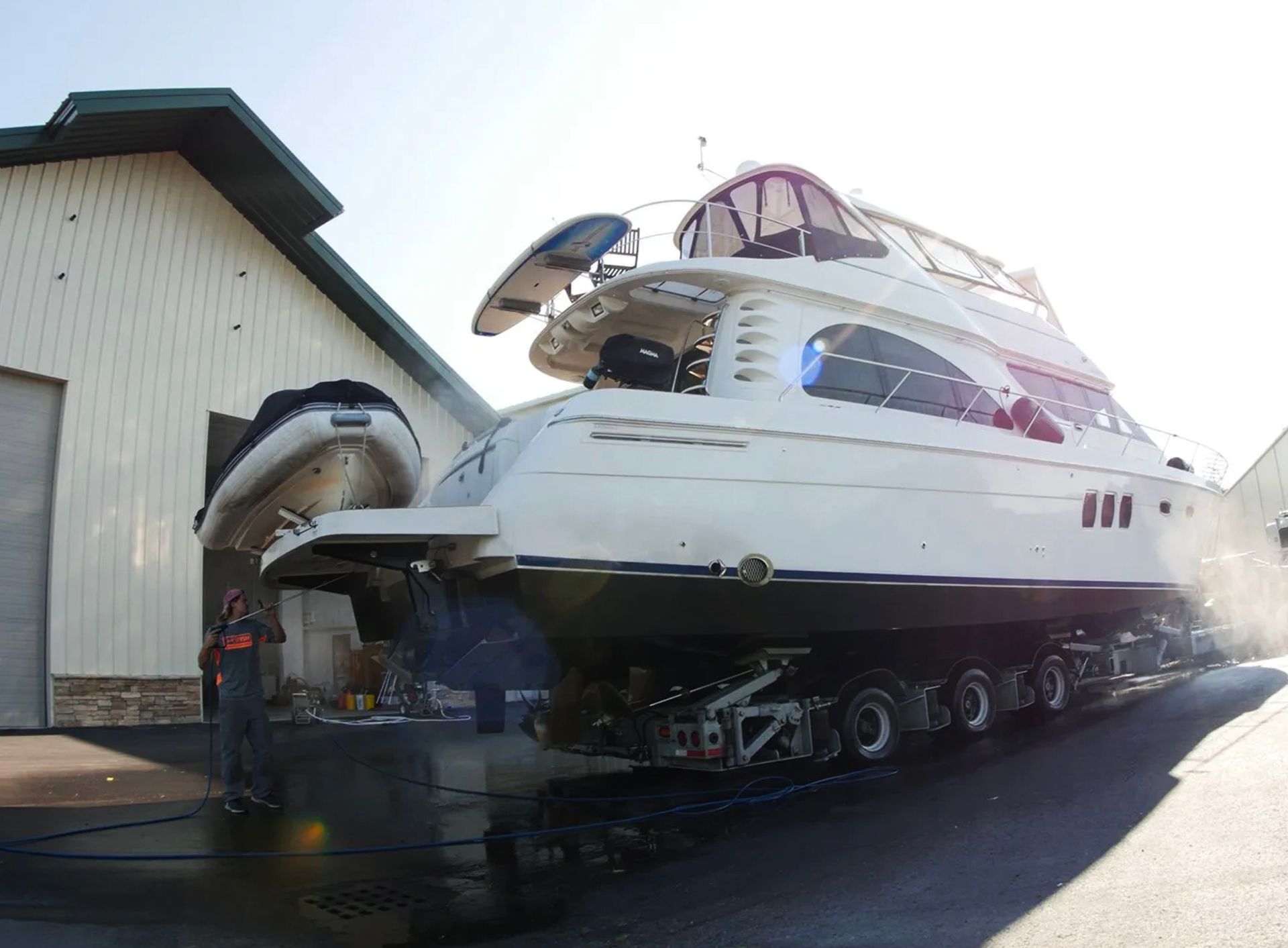 A large white boat is parked in front of a building