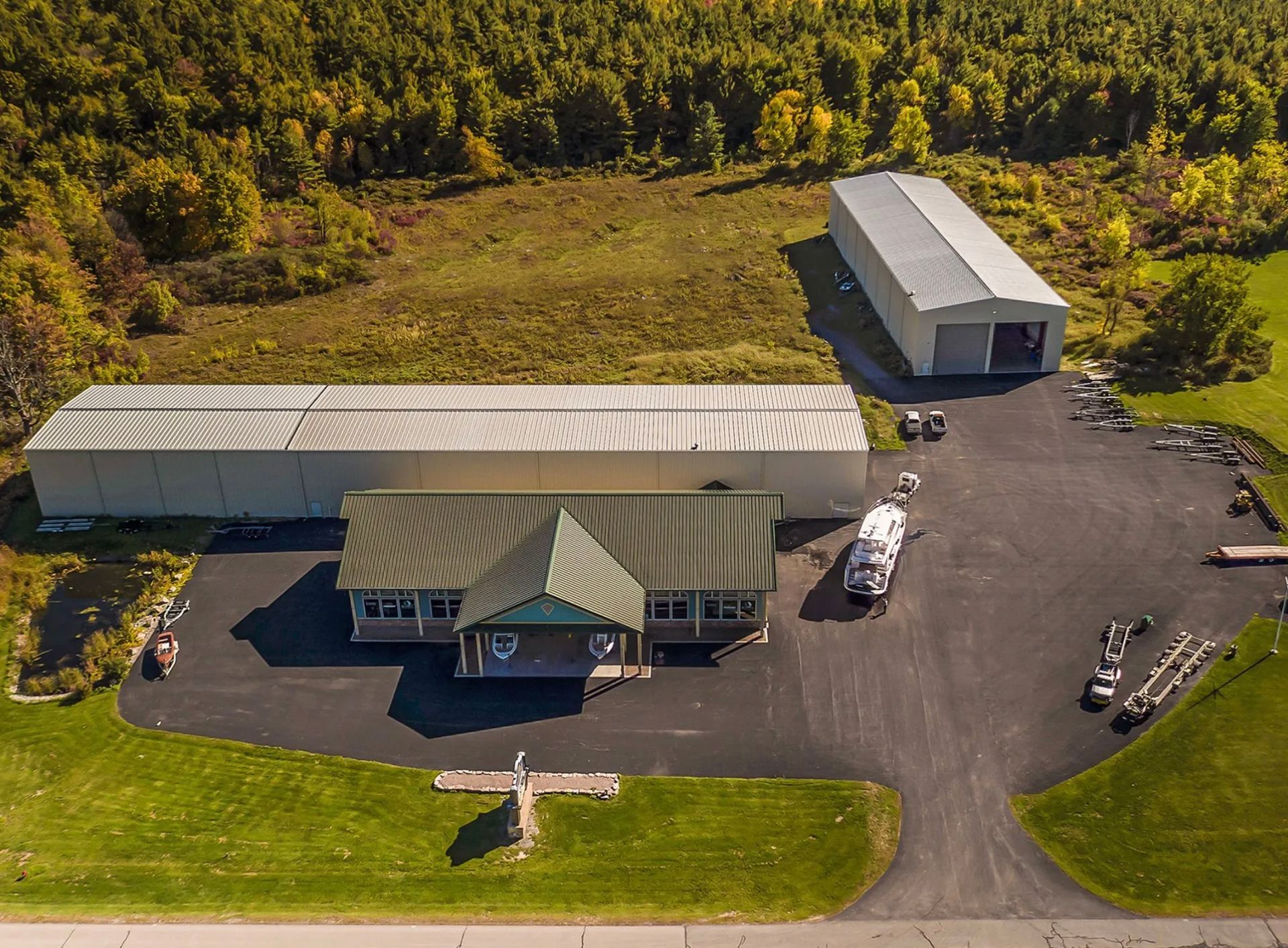 An aerial view of a house with a helicopter parked in front of it