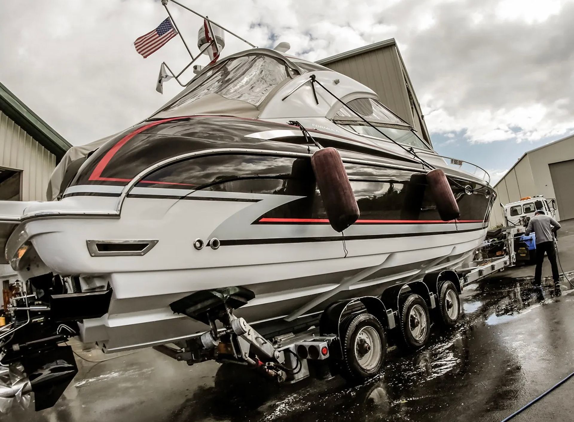A boat is sitting on a trailer in front of a building