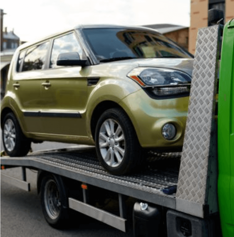 flatbed tow truck lifts a vehicle to tow to auto shop in milford mills, md