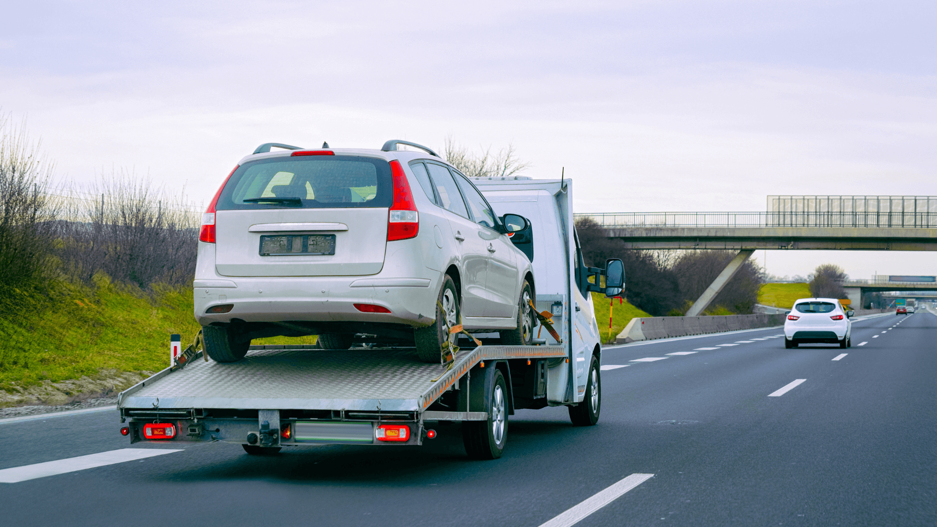 tow truck hauling a broken car long distance from milford mill to Baltimore, md