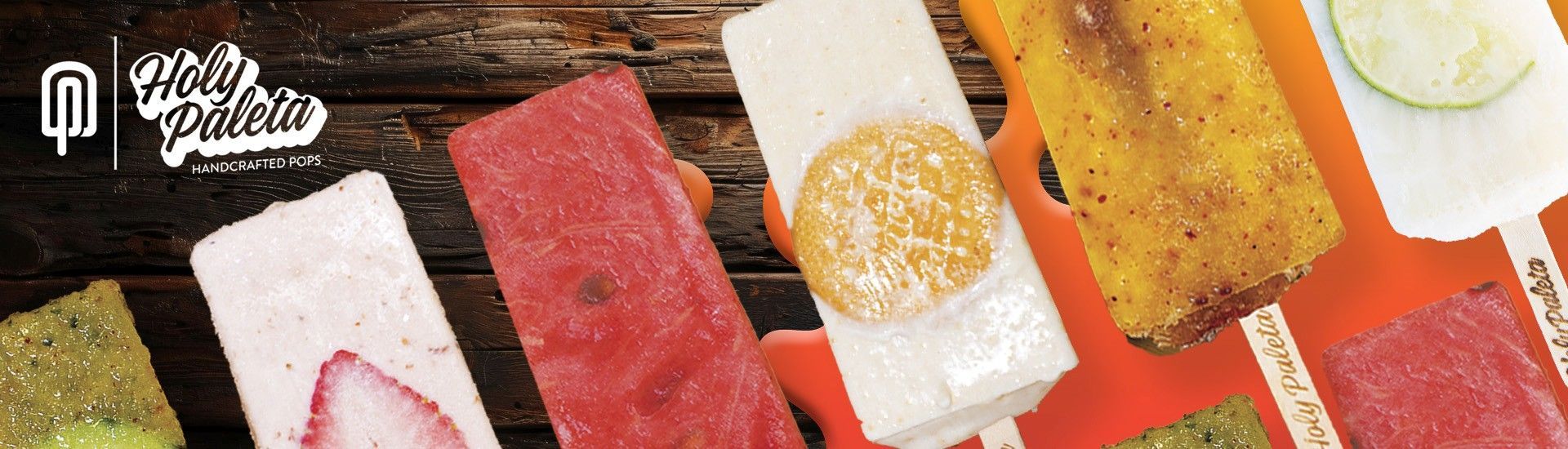 Variety of colorful popsicles on a wooden background.