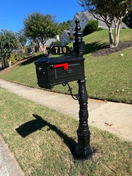 A black mailbox with the number 710 on it