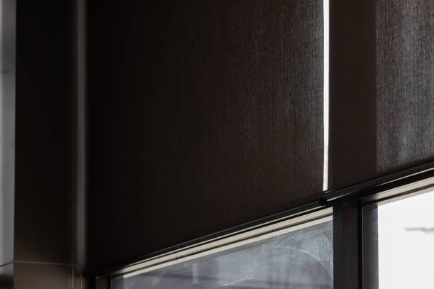 A close up of a window with blinds on it.