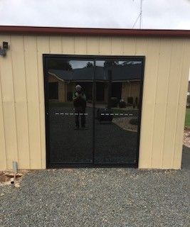 Looking out a window at a blue sky with clouds.