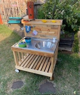 A vase of flowers is sitting on a window sill next to a window with blinds.