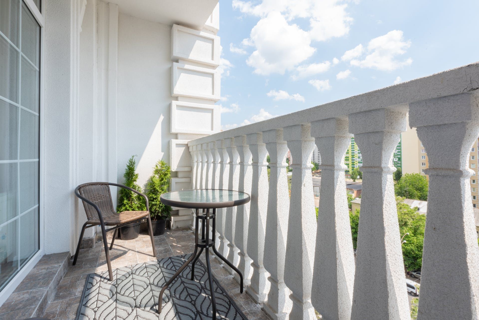 There is a balcony with a table and chairs on it.