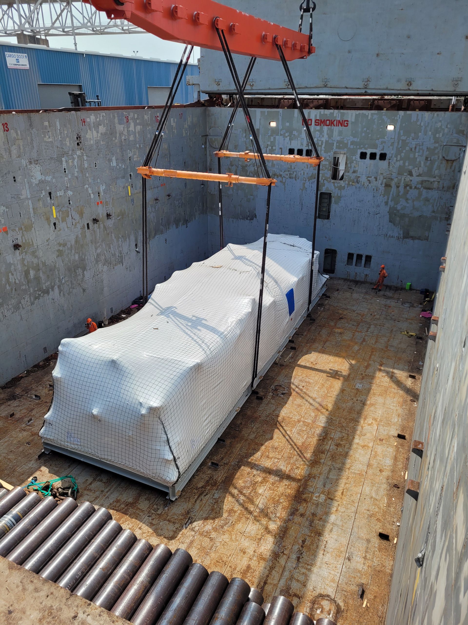 A large container is being lifted by a crane