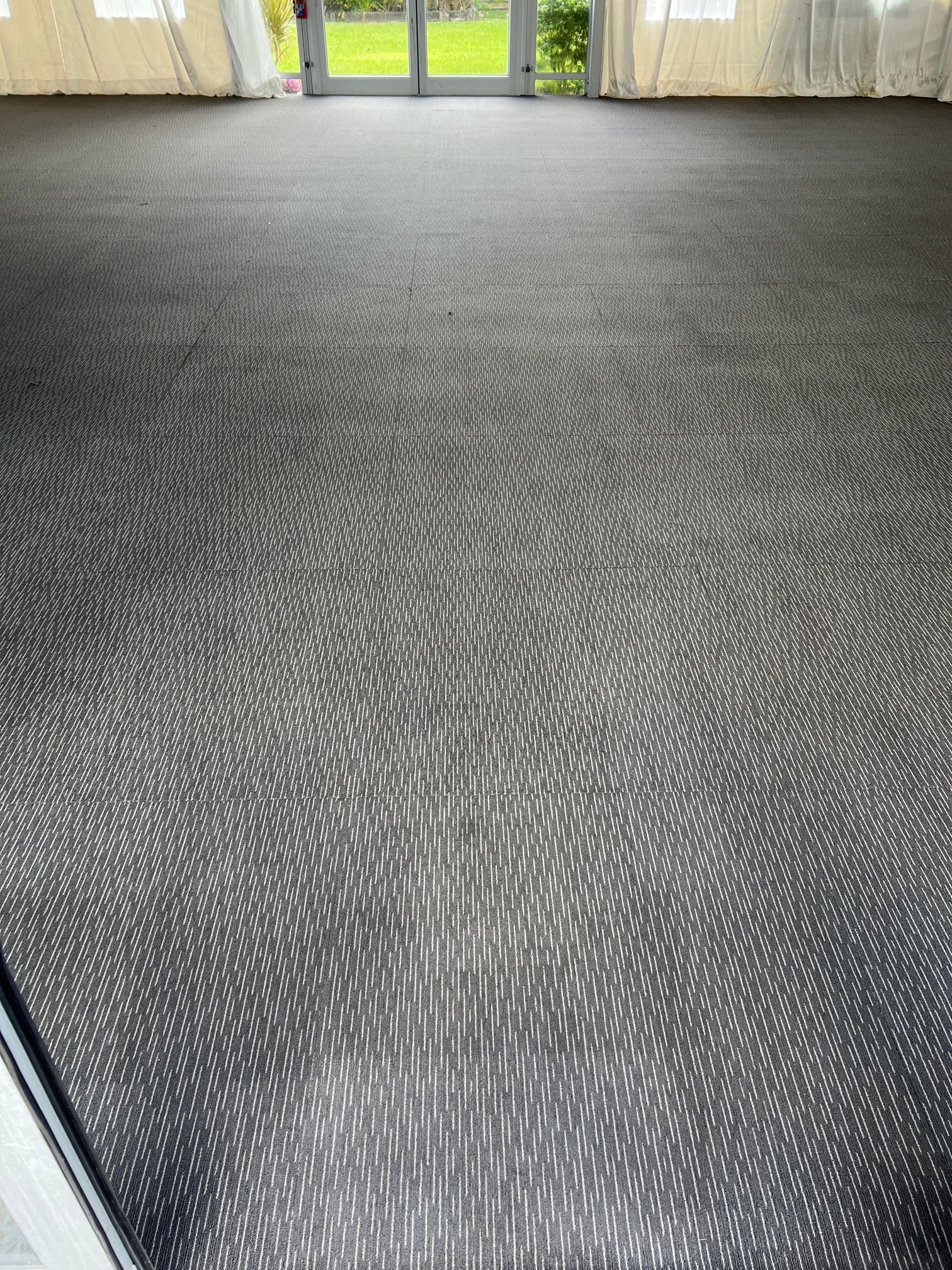 A large carpeted floor in a room with a pattern on it.