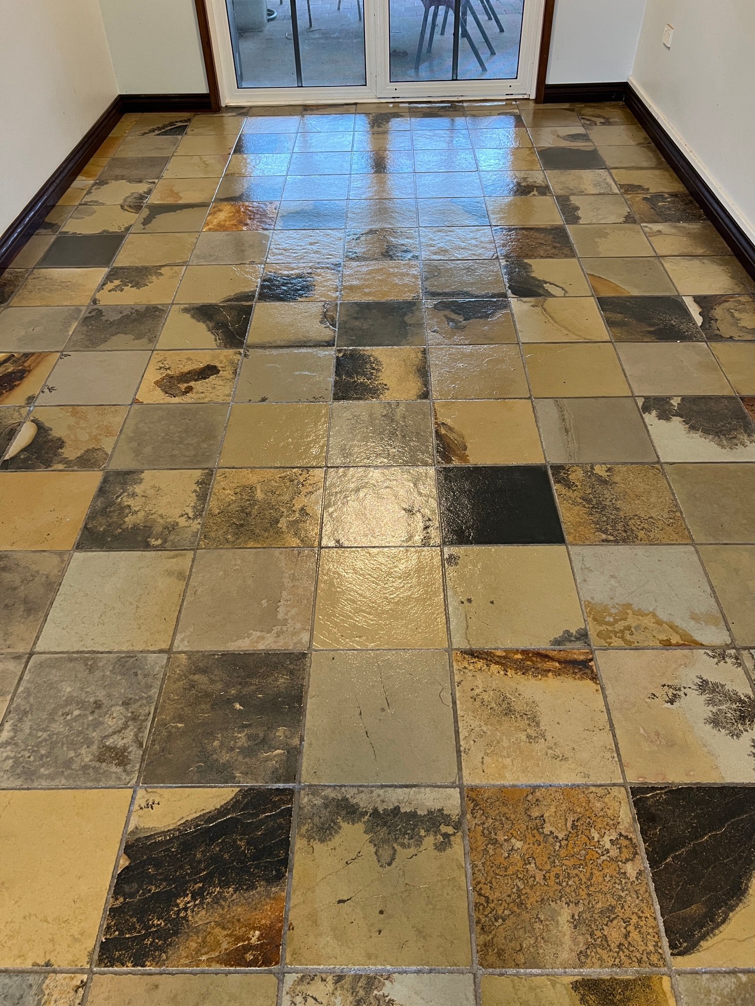 A room with a tiled floor and a sliding glass door.