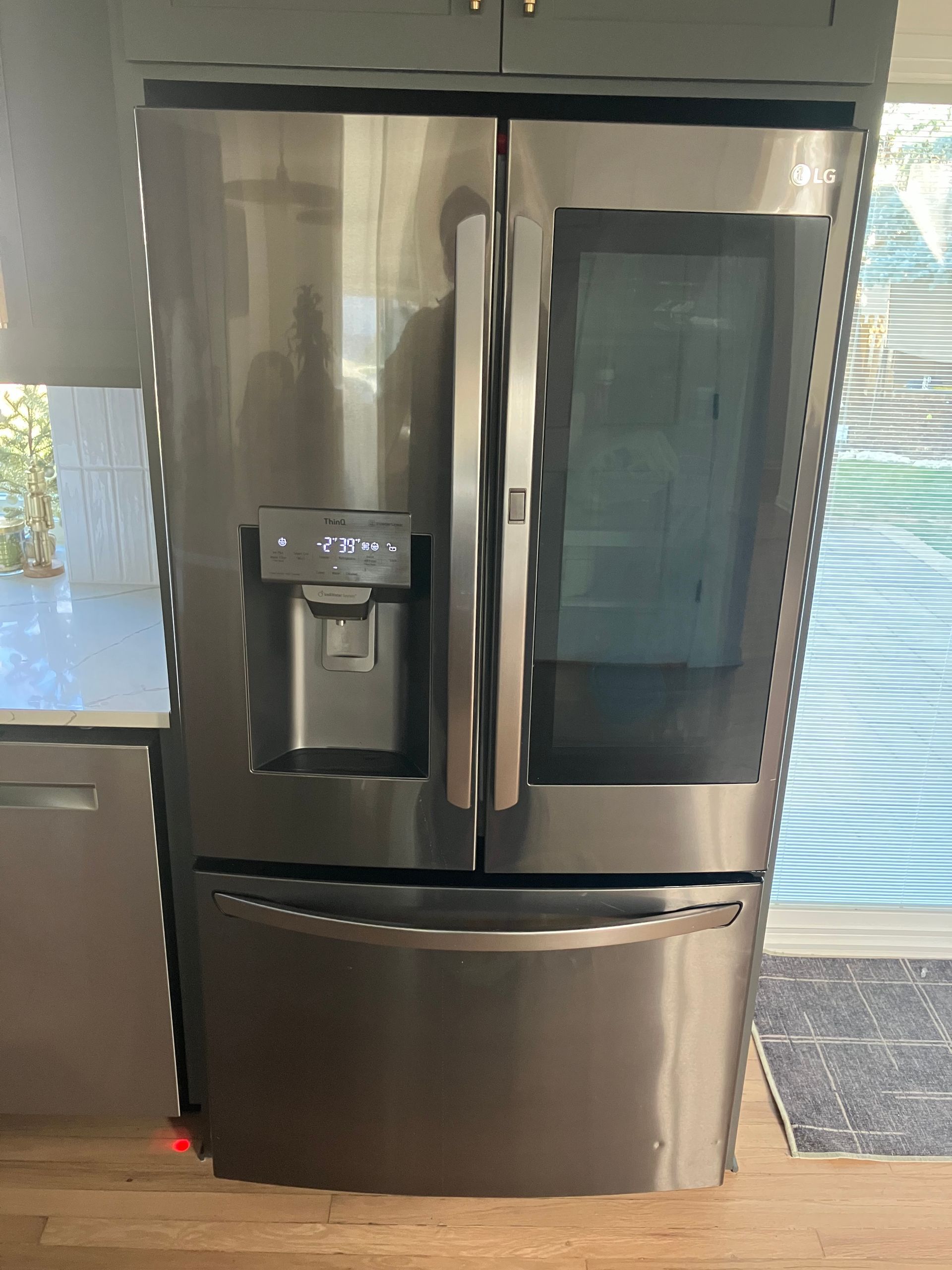 A close up of the inside of a refrigerator on a wooden floor.