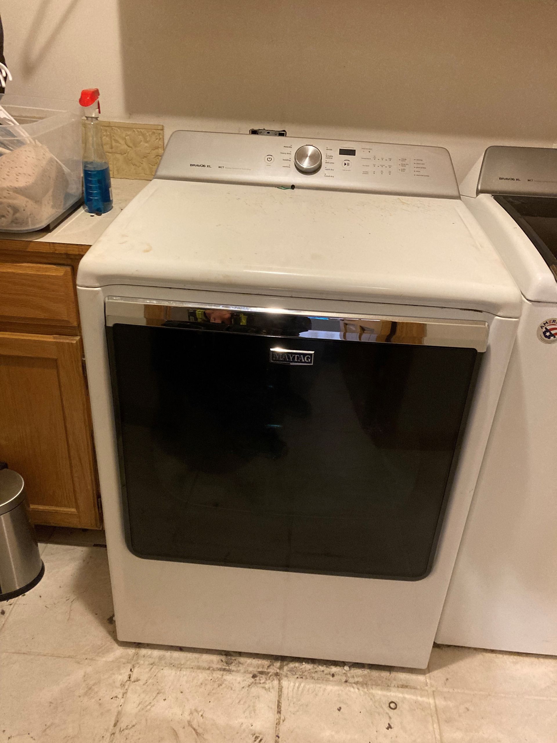 A white washer and dryer are sitting in a laundry room.